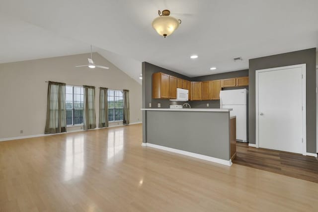 1219 Canyon Trce, Canyon Lake, TX 78133 - kitchen with white appliances, light wood-style floors, ceiling fan, light countertops, and open floor plan