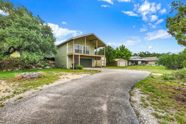 1219 Canyon Trce, Canyon Lake, TX 78133 - view of front facade with a storage unit, driveway, and a garage