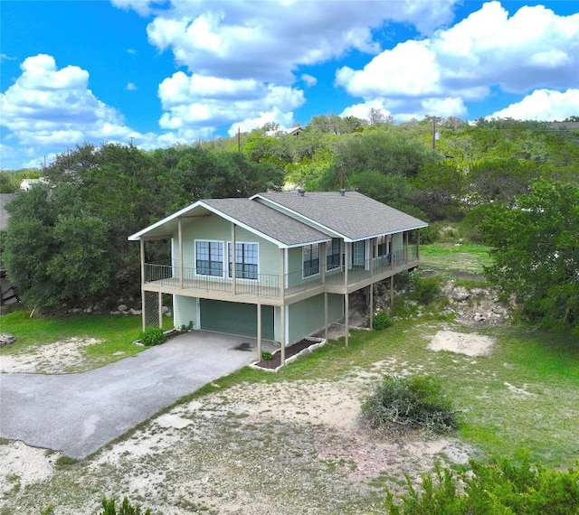 1219 Canyon Trce, Canyon Lake, TX 78133 - view of front of house featuring a garage, driveway, and roof with shingles