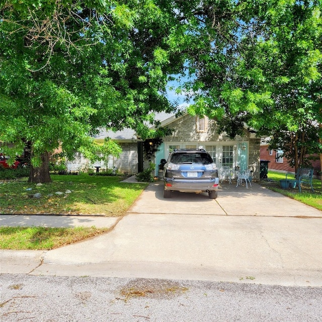 507 Dusty Leather Ct, Pflugerville, TX 78660 - view of property hidden behind natural elements with driveway and a front yard