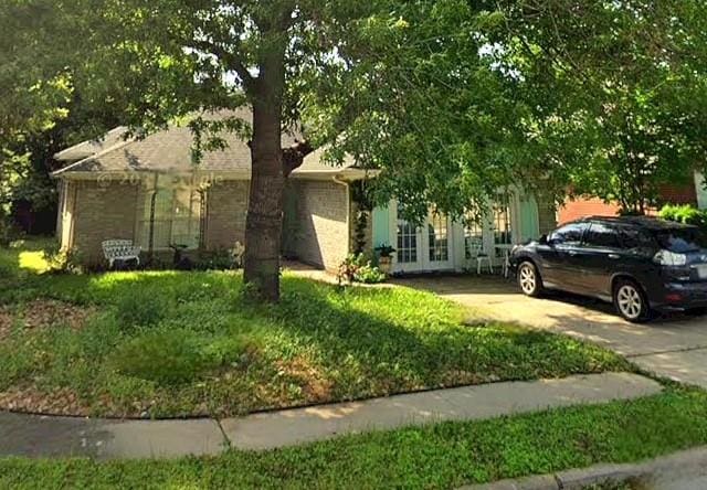 507 Dusty Leather Ct, Pflugerville, TX 78660 - view of property hidden behind natural elements with french doors