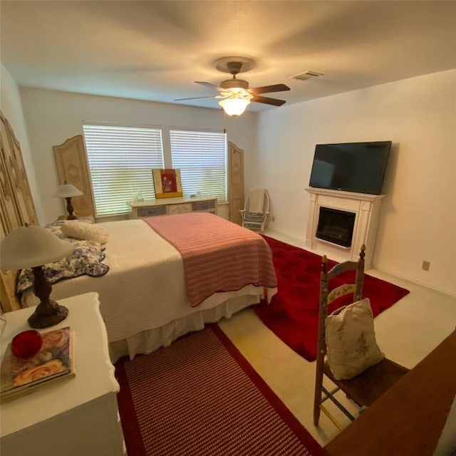 507 Dusty Leather Ct, Pflugerville, TX 78660 - bedroom with carpet floors, ceiling fan, and a fireplace