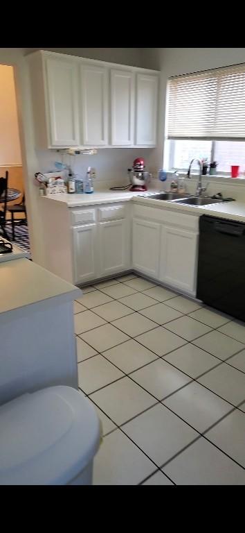 507 Dusty Leather Ct, Pflugerville, TX 78660 - kitchen with black dishwasher, a sink, white cabinets, light countertops, and light tile patterned flooring