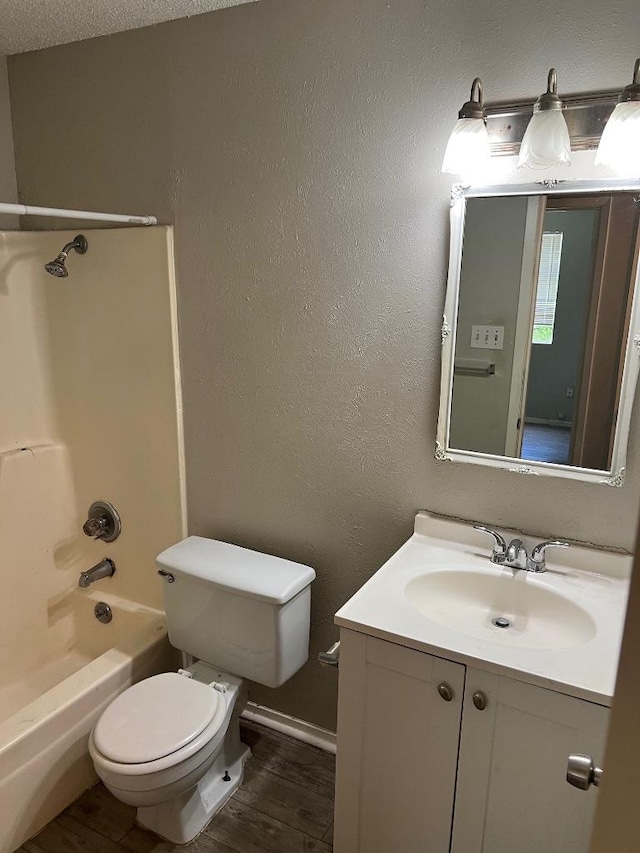 1010 Wayne Dr, Round Rock, TX 78664 - full bathroom featuring vanity, wood finished floors, toilet,  shower combination, and baseboards