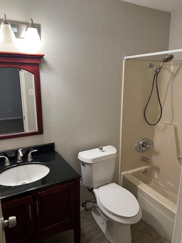 1010 Wayne Dr, Round Rock, TX 78664 - bathroom featuring vanity, toilet, tub / shower combination, and wood finished floors