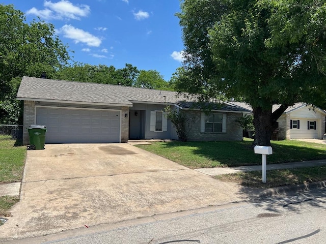 1010 Wayne Dr, Round Rock, TX 78664 - ranch-style house with brick siding, an attached garage, and driveway