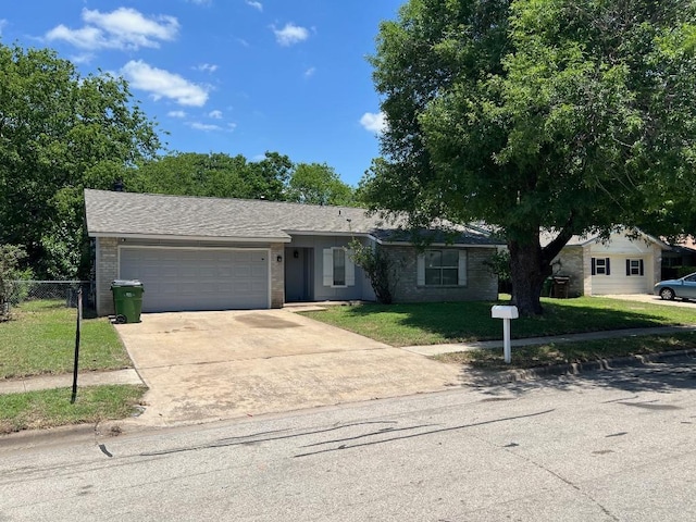 1010 Wayne Dr, Round Rock, TX 78664 - ranch-style home featuring an attached garage, concrete driveway, and brick siding