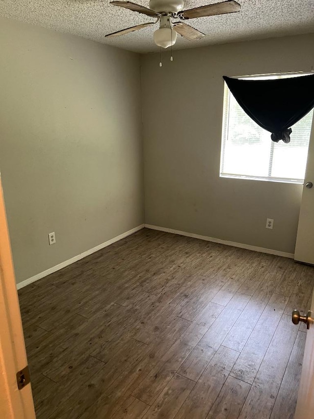 1010 Wayne Dr, Round Rock, TX 78664 - spare room featuring ceiling fan, dark wood-style flooring, a textured ceiling, and baseboards