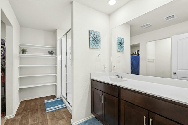 101 Calgary Ln, San Marcos, TX 78666 - full bathroom with a spacious closet, wood finished floors, vanity, and a stall shower