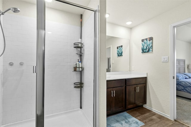 101 Calgary Ln, San Marcos, TX 78666 - ensuite bathroom featuring wood finished floors, vanity, and a stall shower