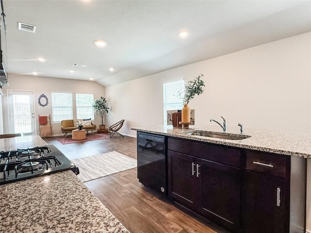 101 Calgary Ln, San Marcos, TX 78666 - kitchen with black dishwasher, dark wood-type flooring, light stone countertops, open floor plan, and recessed lighting