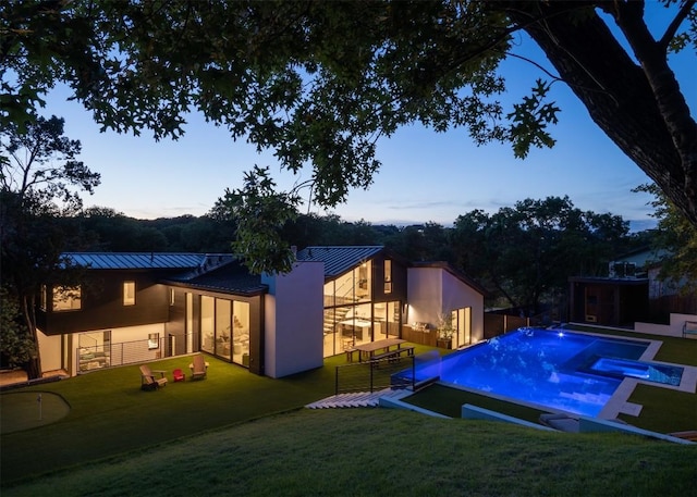 2503 Dip Cv, Austin, TX 78704 - pool at dusk with a pool with connected hot tub and a patio