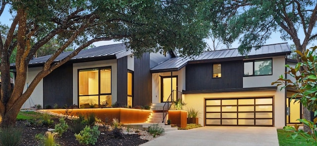 2503 Dip Cv, Austin, TX 78704 - view of front of property with a standing seam roof, a metal roof, driveway, a garage, and stucco siding