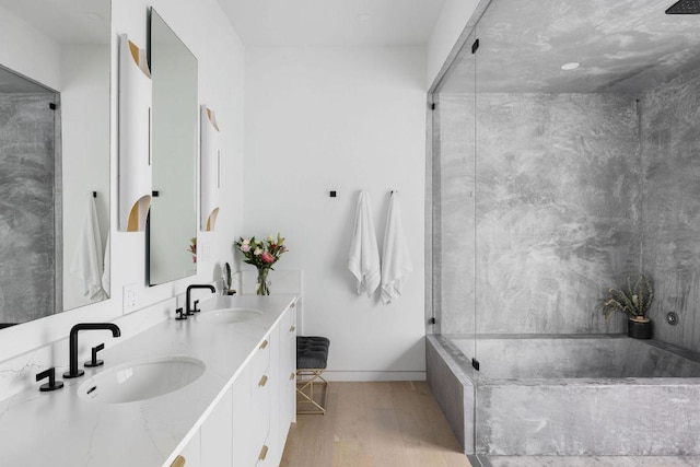 2503 Dip Cv, Austin, TX 78704 - bathroom with a garden tub, wood finished floors, double vanity, baseboards, and a shower with door