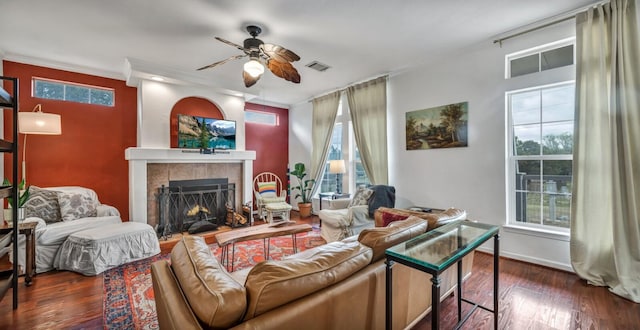 1302 White Tail, Horseshoe Bay, TX 78657 - living room with ceiling fan, a tiled fireplace, wood finished floors, healthy amount of natural light, and crown molding