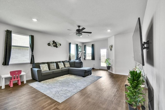 116 Charles Trl, Georgetown, TX 78626 - living area with wood finished floors, a textured ceiling, a ceiling fan, baseboards, and recessed lighting
