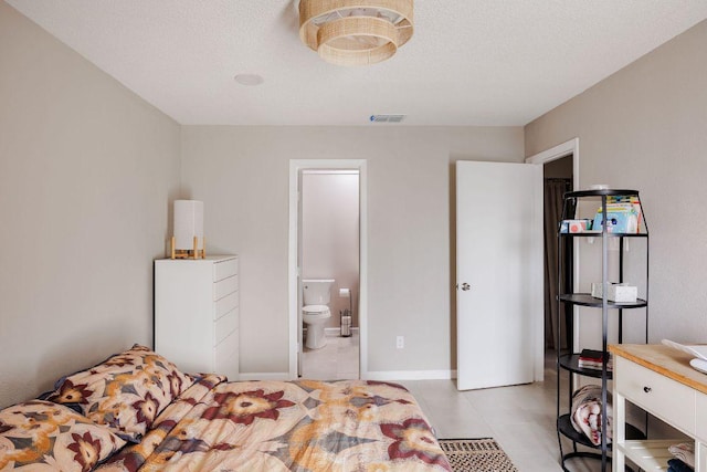 1748 Ohlen Rd Unit 14, Austin, TX 78757 - bedroom featuring light tile patterned flooring and ensuite bath