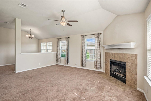 14513 Martial Eagle Dr, Elgin, TX 78621 - unfurnished living room with lofted ceiling, a ceiling fan, a tiled fireplace, carpet, and a chandelier