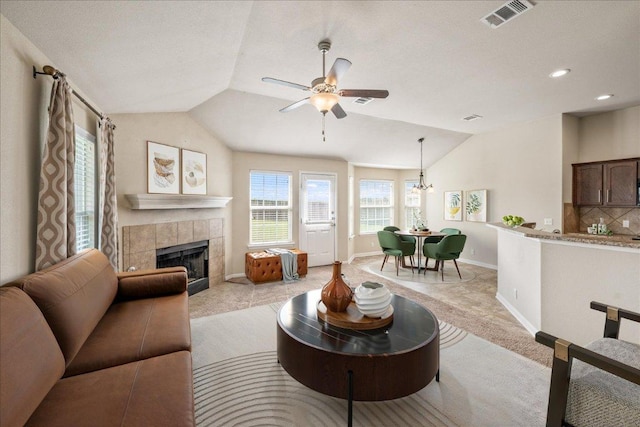 14513 Martial Eagle Dr, Elgin, TX 78621 - living area featuring vaulted ceiling, ceiling fan, light colored carpet, a tile fireplace, and recessed lighting