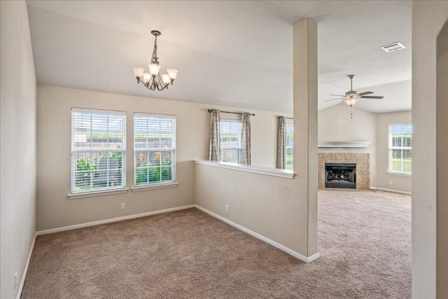 14513 Martial Eagle Dr, Elgin, TX 78621 - unfurnished room featuring carpet floors, lofted ceiling, a chandelier, a tile fireplace, and a ceiling fan