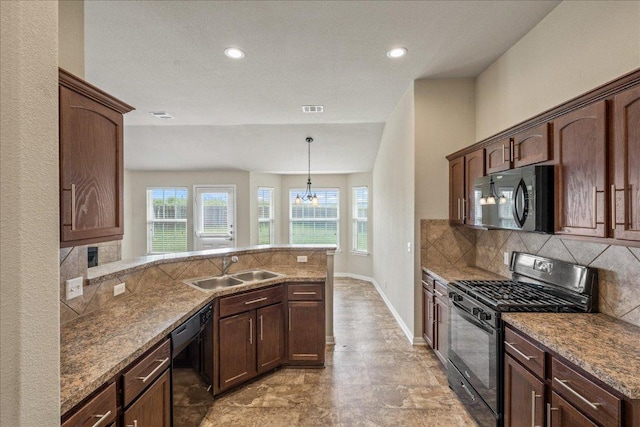 14513 Martial Eagle Dr, Elgin, TX 78621 - kitchen with black appliances, healthy amount of natural light, decorative backsplash, and recessed lighting