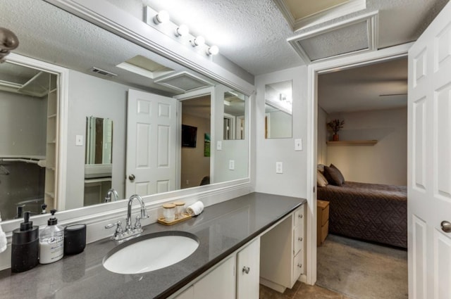 2529 Rio Grande St Unit 51, Austin, TX 78705 - bathroom with connected bathroom, vanity, and a textured ceiling
