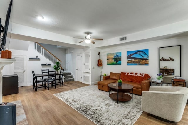 2529 Rio Grande St Unit 51, Austin, TX 78705 - living room featuring stairway, a ceiling fan, light wood-style flooring, and baseboards