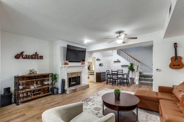 2529 Rio Grande St Unit 51, Austin, TX 78705 - living area featuring stairs, ceiling fan, a premium fireplace, wood finished floors, and vaulted ceiling