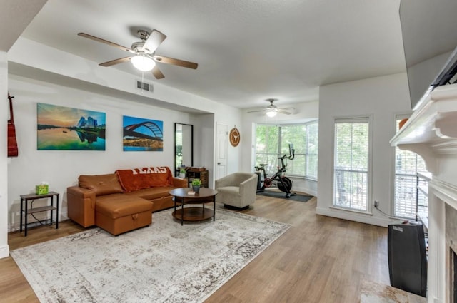 2529 Rio Grande St Unit 51, Austin, TX 78705 - living room featuring a ceiling fan, a high end fireplace, and light wood-type flooring