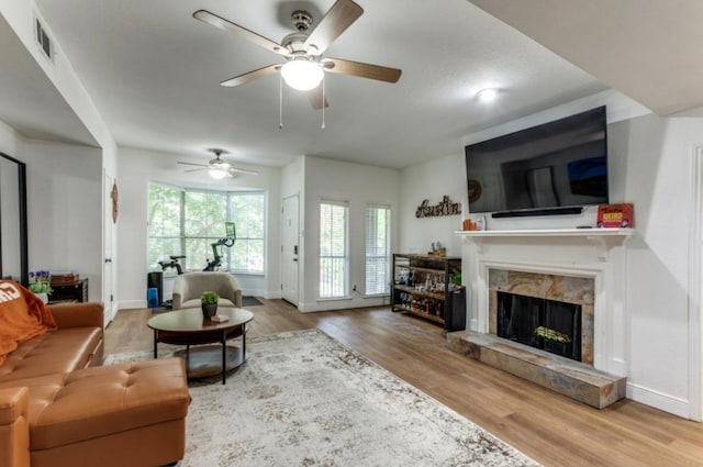 2529 Rio Grande St Unit 51, Austin, TX 78705 - living room featuring a fireplace, ceiling fan, wood finished floors, and baseboards