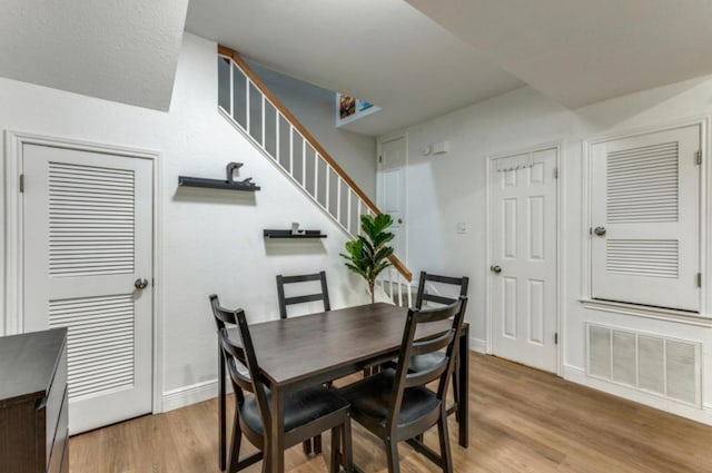 2529 Rio Grande St Unit 51, Austin, TX 78705 - dining room with light wood-style flooring, stairway, and baseboards