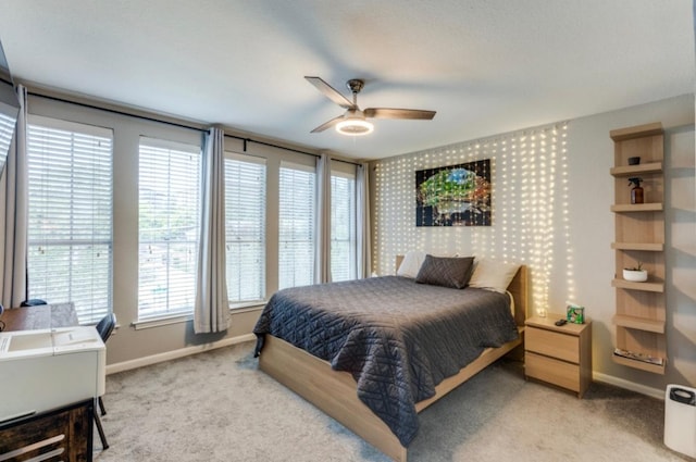 2529 Rio Grande St Unit 51, Austin, TX 78705 - carpeted bedroom featuring baseboards, multiple windows, and a ceiling fan