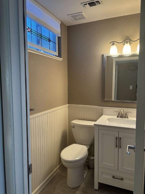 18220 Shepherds Corral, Dripping Springs, TX 78620 - half bath featuring vanity, toilet, wainscoting, and a textured wall