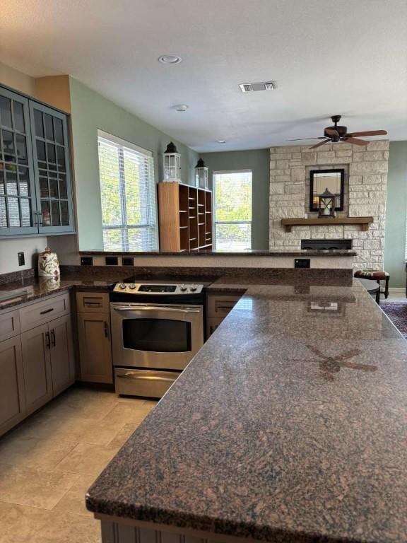 18220 Shepherds Corral, Dripping Springs, TX 78620 - kitchen featuring electric stove, plenty of natural light, ceiling fan, glass insert cabinets, and recessed lighting