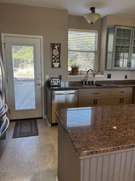 18220 Shepherds Corral, Dripping Springs, TX 78620 - kitchen featuring dishwasher, dark stone counters, glass insert cabinets, and light tile patterned floors