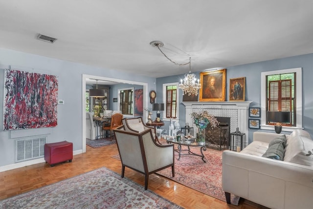 220 River Rapids Rd, Wimberley, TX 78676 - living room with a chandelier, baseboards, and a tile fireplace