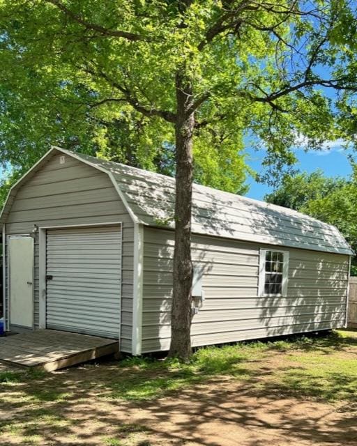1375 Lovers Ln, Bastrop, TX 78602 - detached garage featuring a storage unit