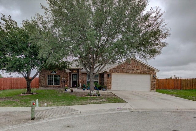 700 Indian Blanket St, Lockhart, TX 78644 - view of property hidden behind natural elements featuring a garage, brick siding, and driveway