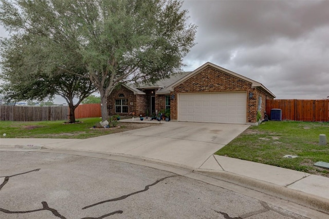 700 Indian Blanket St, Lockhart, TX 78644 - view of front of property featuring brick siding, a garage, and concrete driveway