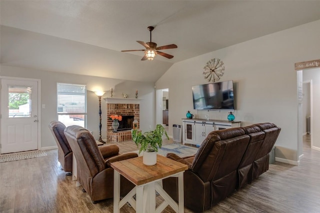 700 Indian Blanket St, Lockhart, TX 78644 - living area featuring light wood finished floors, a ceiling fan, lofted ceiling, and a fireplace