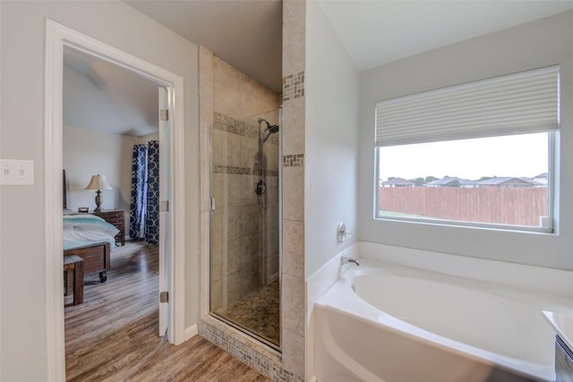 700 Indian Blanket St, Lockhart, TX 78644 - ensuite bathroom with a bath, wood finished floors, and a shower stall