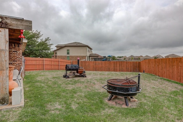 700 Indian Blanket St, Lockhart, TX 78644 - fenced backyard with an outdoor fire pit