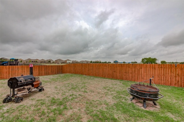 700 Indian Blanket St, Lockhart, TX 78644 - fenced backyard featuring an outdoor fire pit