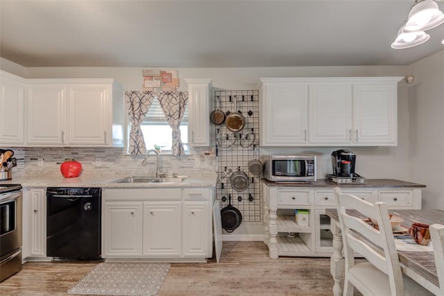 700 Indian Blanket St, Lockhart, TX 78644 - kitchen featuring appliances with stainless steel finishes, white cabinetry, light wood-style floors, and decorative backsplash