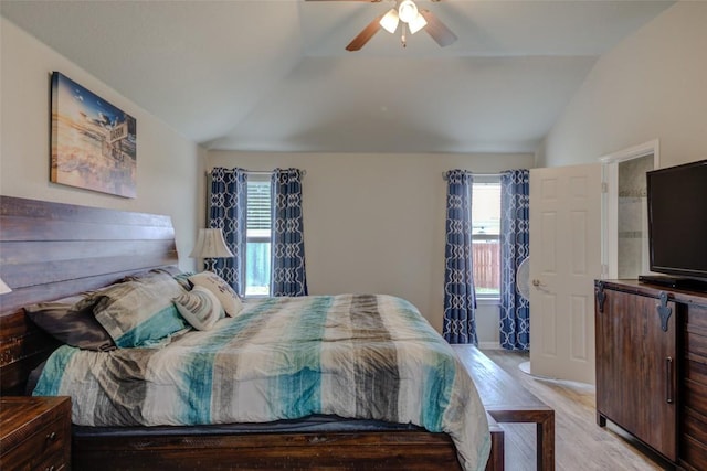 700 Indian Blanket St, Lockhart, TX 78644 - bedroom with vaulted ceiling, wood finished floors, multiple windows, and a ceiling fan