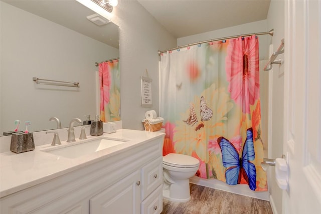 700 Indian Blanket St, Lockhart, TX 78644 - full bath featuring vanity, wood finished floors, and shower / bath combo with shower curtain