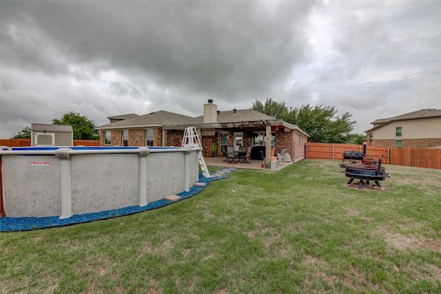 700 Indian Blanket St, Lockhart, TX 78644 - fenced backyard featuring a fire pit and a patio area