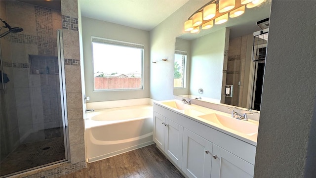 700 Indian Blanket St, Lockhart, TX 78644 - full bath with a shower stall, a garden tub, double vanity, wood finished floors, and healthy amount of natural light