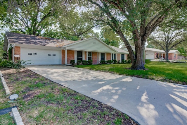 2502 Greenlawn Pkwy, Austin, TX 78757 - ranch-style house with brick siding, a garage, driveway, and a front lawn