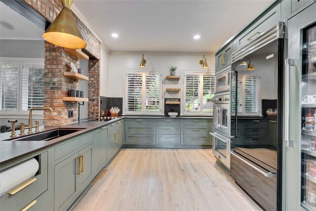 4812 Mantle Dr, Austin, TX 78746 - kitchen featuring open shelves, appliances with stainless steel finishes, plenty of natural light, light wood-type flooring, and crown molding
